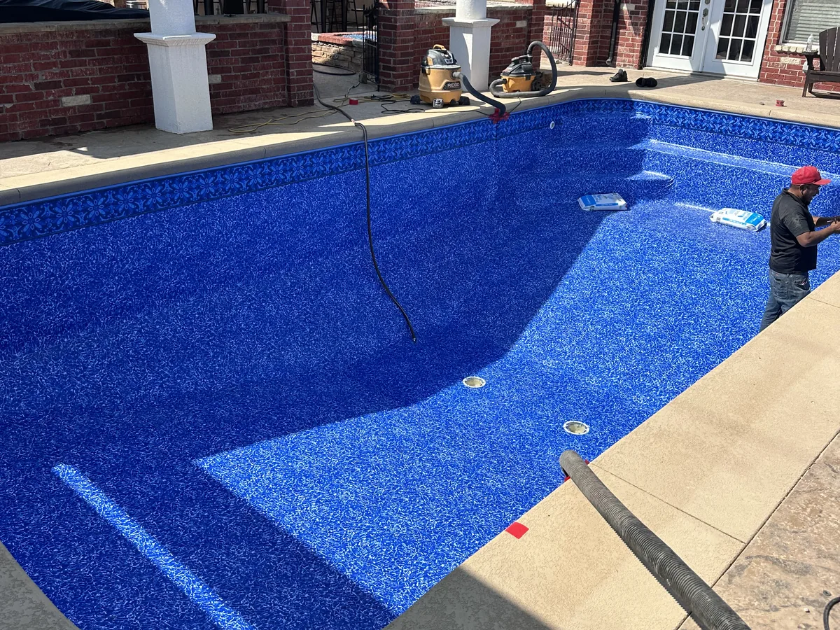 Blue mosaic tile pool with tanning ledge