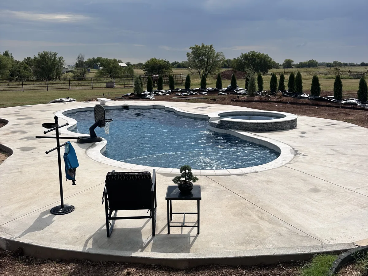 Curved pool with broom finish concrete decking