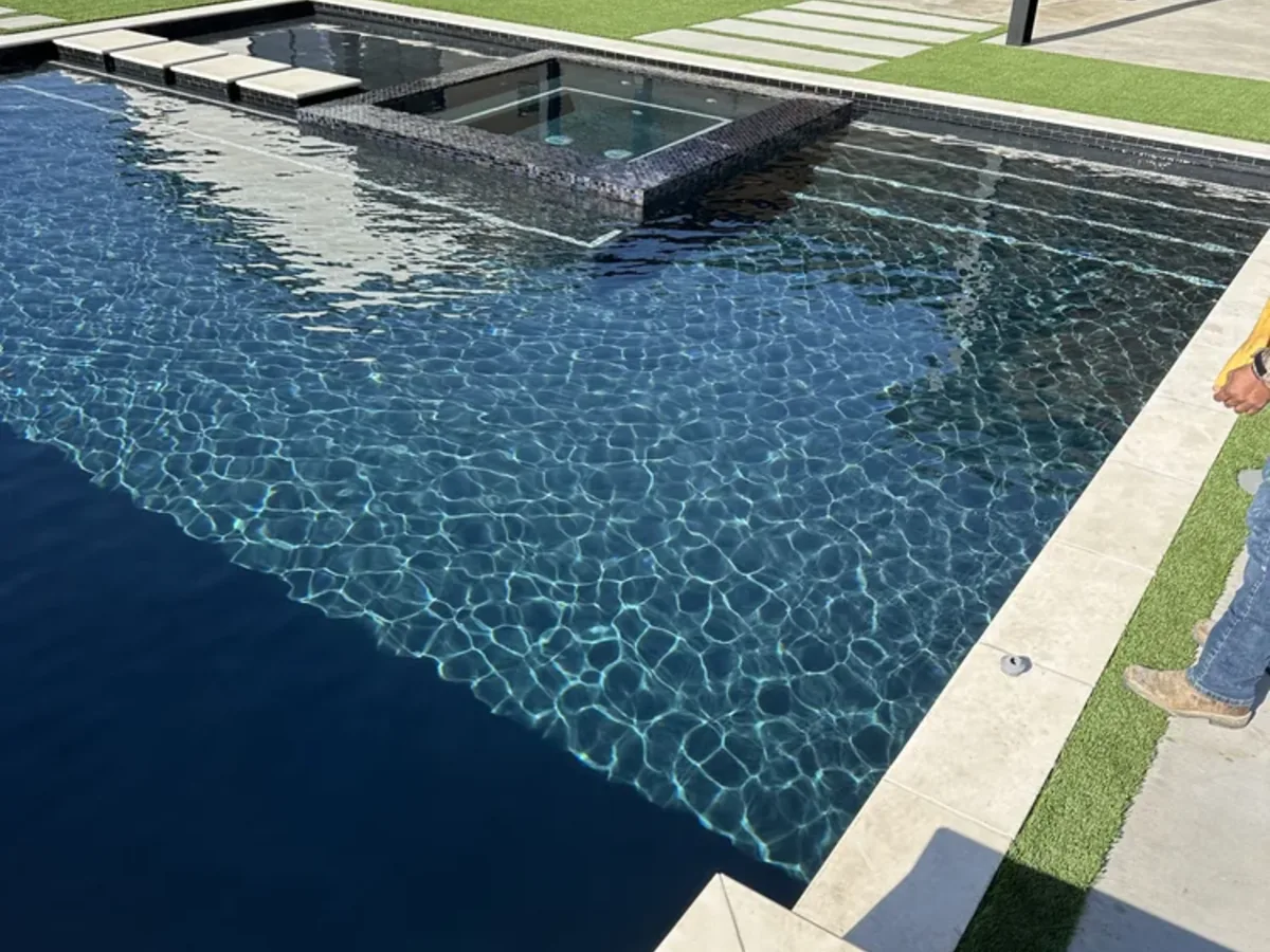 Dark bottom pool with sun ledge and stepping pads