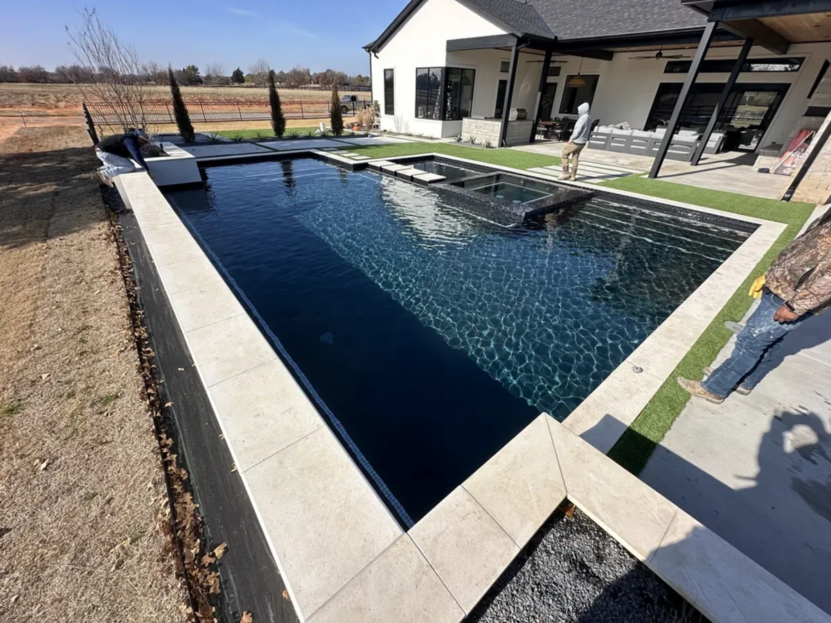 Dark bottom pool with perimeter overflow edge