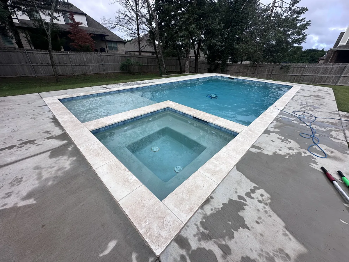 Finished pool and spa with travertine deck