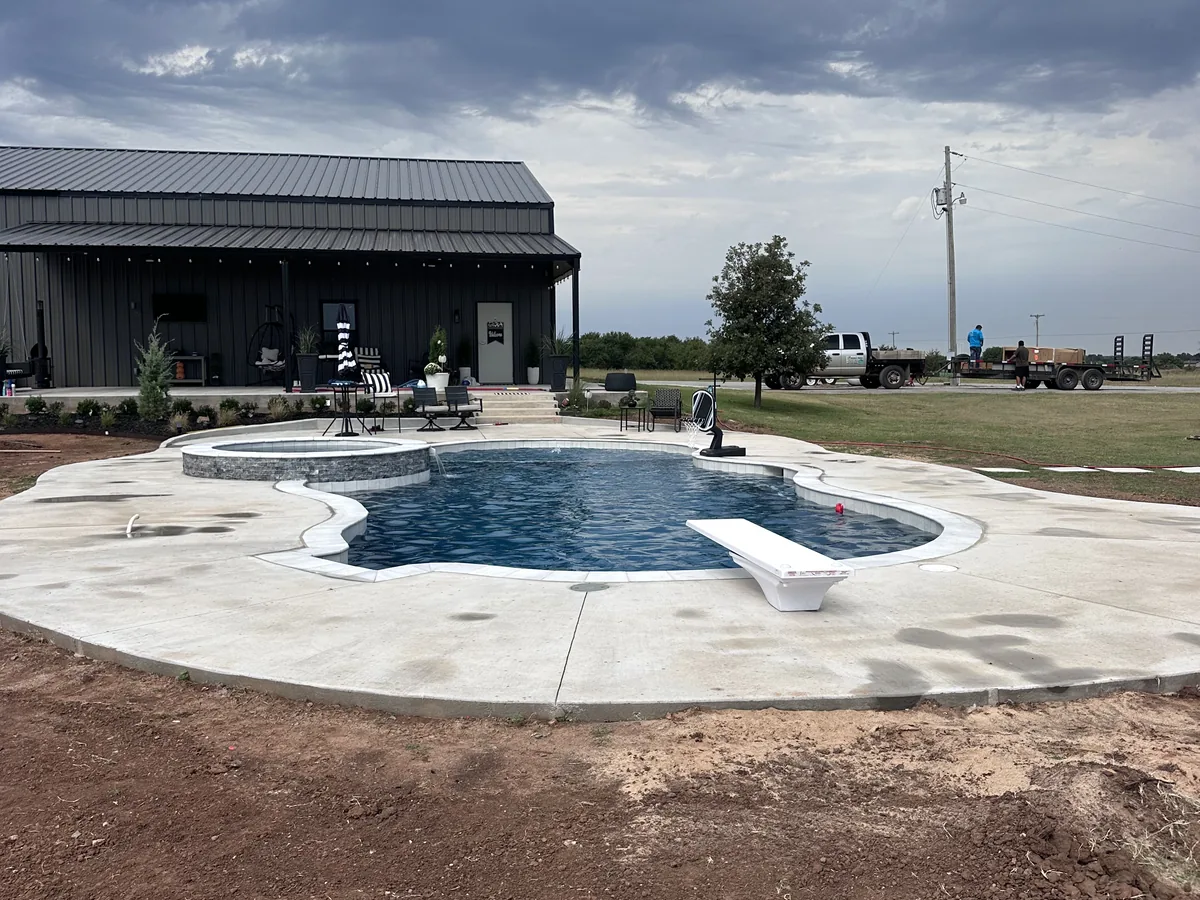 Freeform pool and spa in a finished backyard