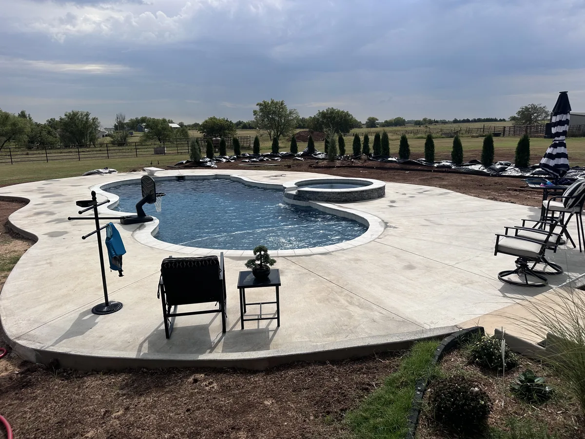 Freeform pool with poolside seating area