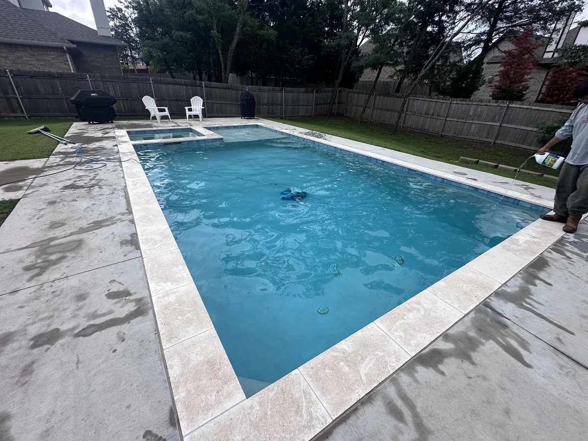 Geometric pool with wide travertine deck