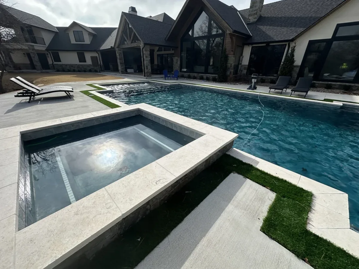 Raised square spa with spillover and turf deck