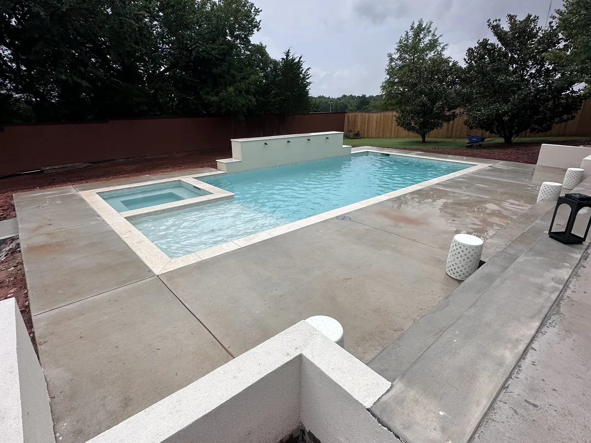 Rectangular pool with tanning ledge and cool deck